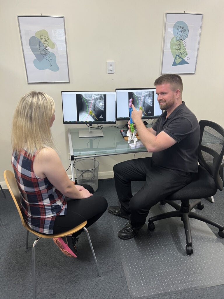Dr Sam Johnson (Chiropractor) reviewing findings with patient