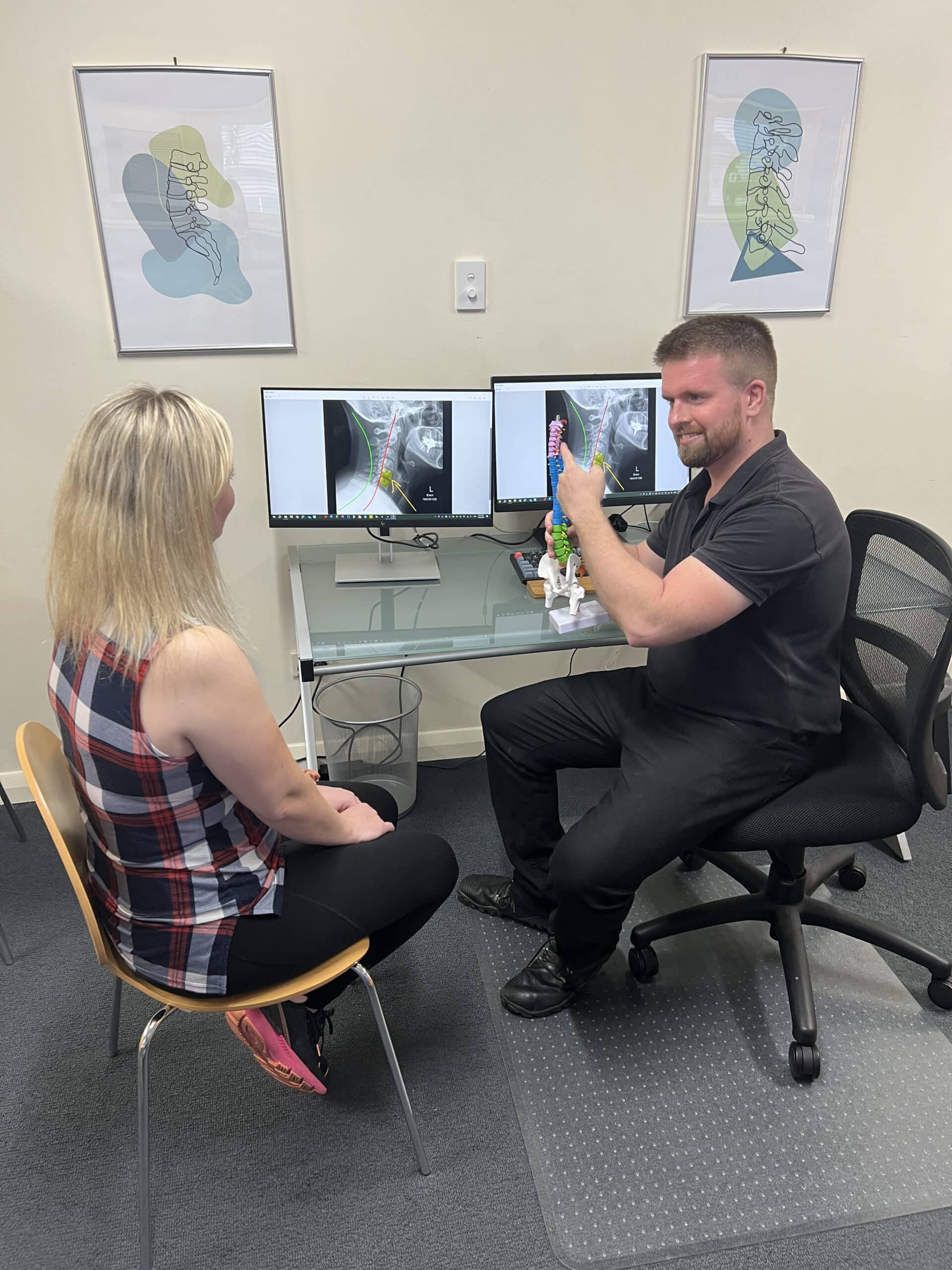 Dr Sam Johnson (Chiropractor) reviewing sciatica assessment findings with patient