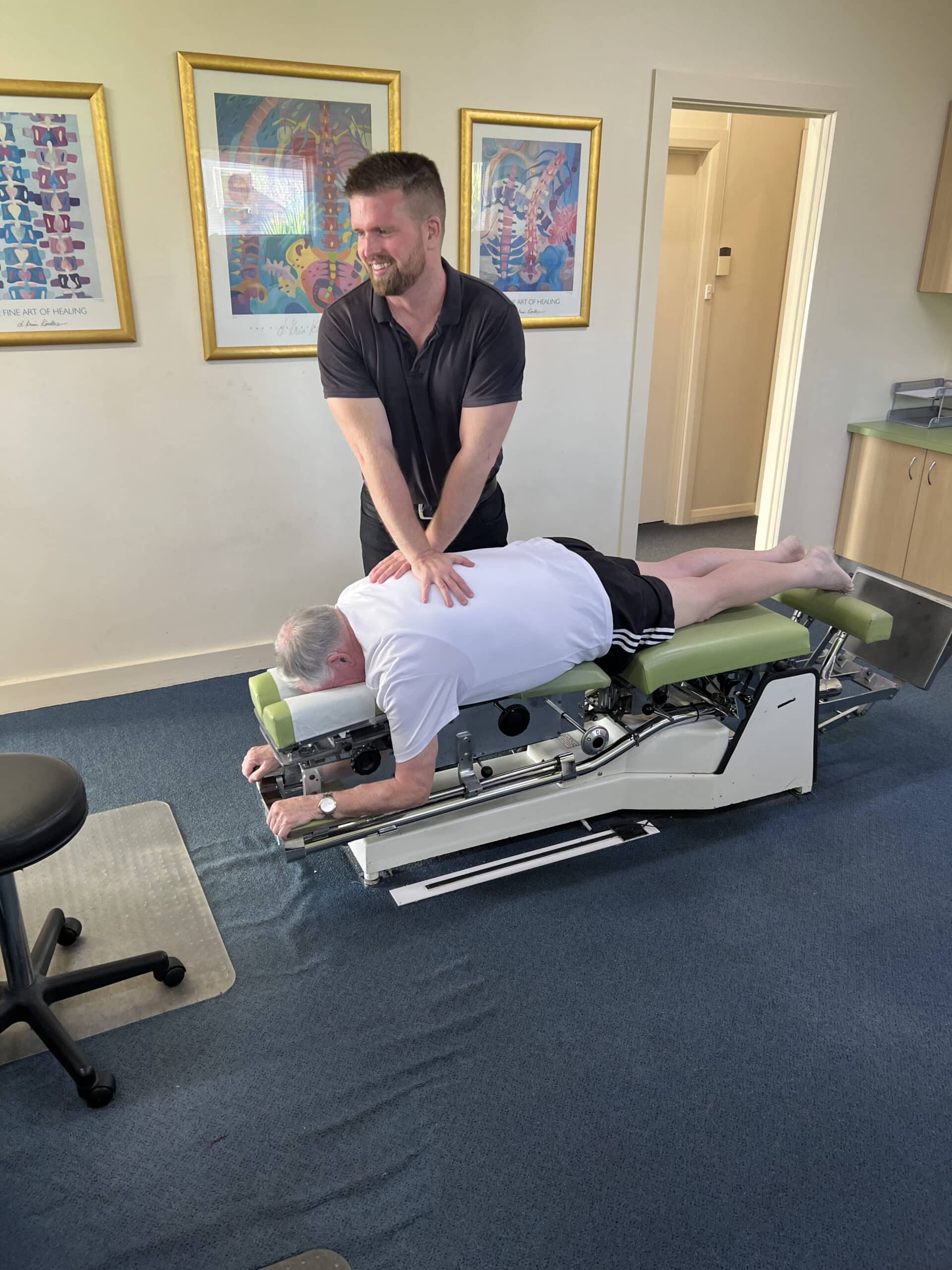 Dr Sam Johnson performing spinal adjustment on patient at Stapleton Chiropractic Adelaide