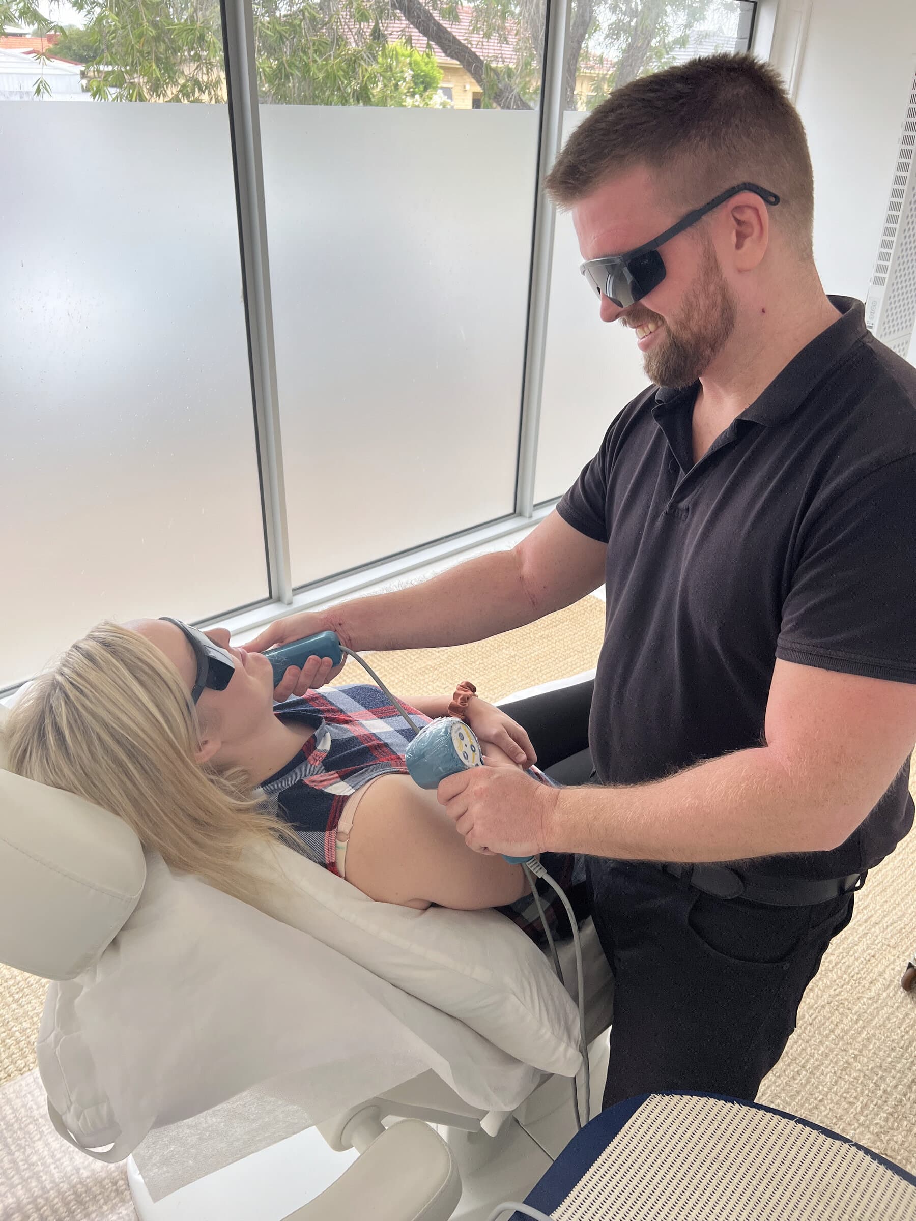Cold laser therapy being applied to a patient's shoulder at Stapleton Chiropractic, Plympton Park Adelaide