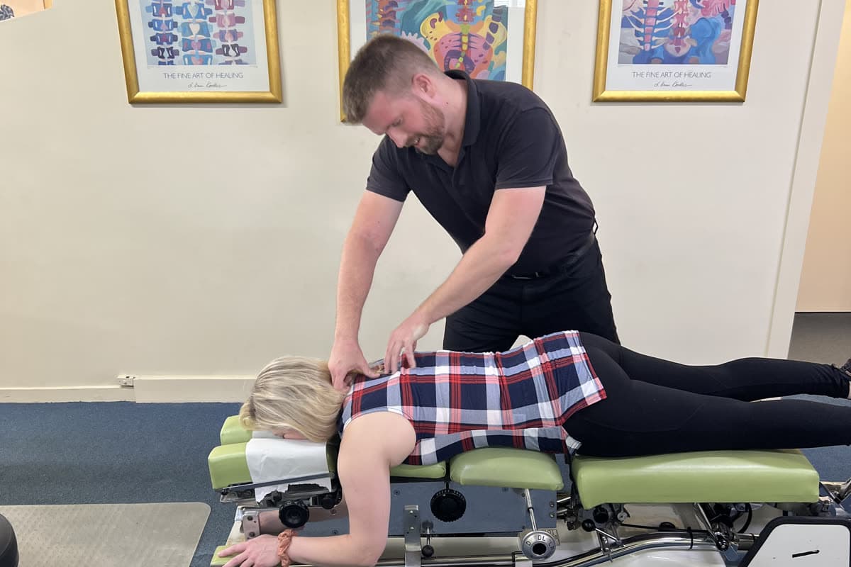 Dr Sam Johnson (Chiropractor) completing a physical assessment